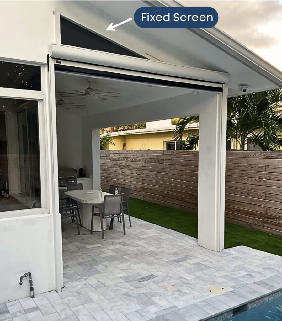 A covered patio with a dining table and chairs, next to a pool. The patio has a partially lowered retractable screen labeled Fixed Screen at the top. A wooden fence and plants are visible in the background.